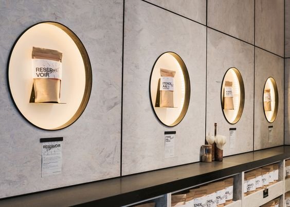 Illuminated circular wall display fixtures with product packages in a retail interior