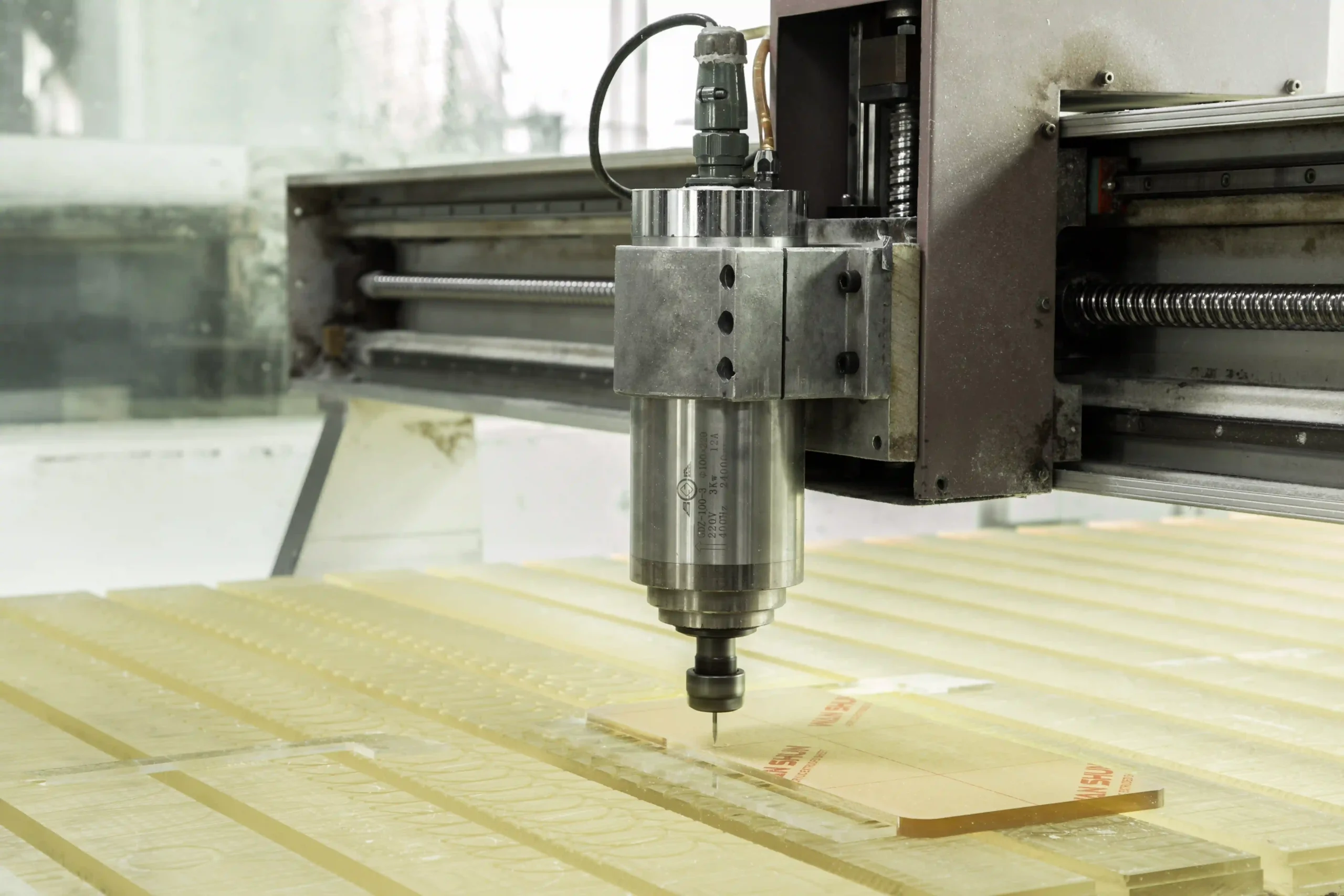CNC router cutting sheet material on a fabrication table