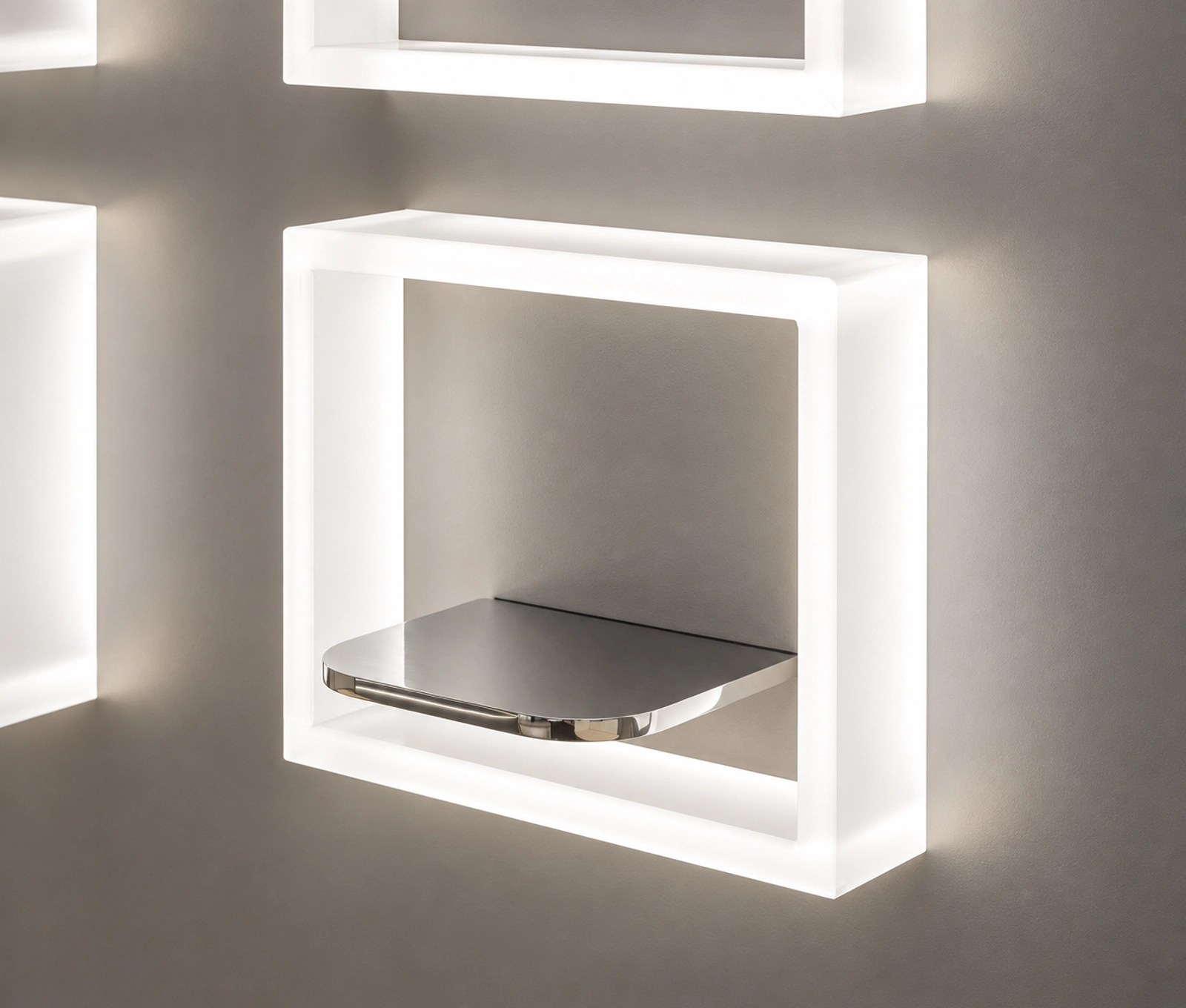 Illuminated white square wall frame with a polished metal shelf